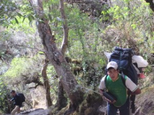A porter listens to his 'vintage iPod' while he carries our camping supplies