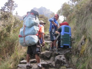 A porter adjusts his load along the way