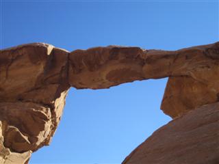 We walk across a massive stone "bridge"