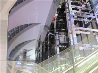 Glass elevators in front of a waterfall