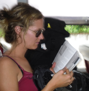 Me in my skuzzed out traveller look (don't comb my hair for days, no makeup, semi-dirty clnothes) attempting to read The Lonely Planet on the bus